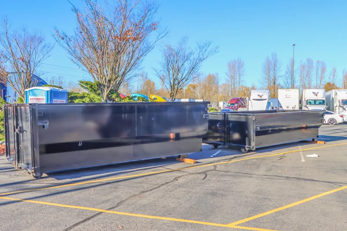 Professional dumpster rental service with roll-off container on residential driveway in Dover